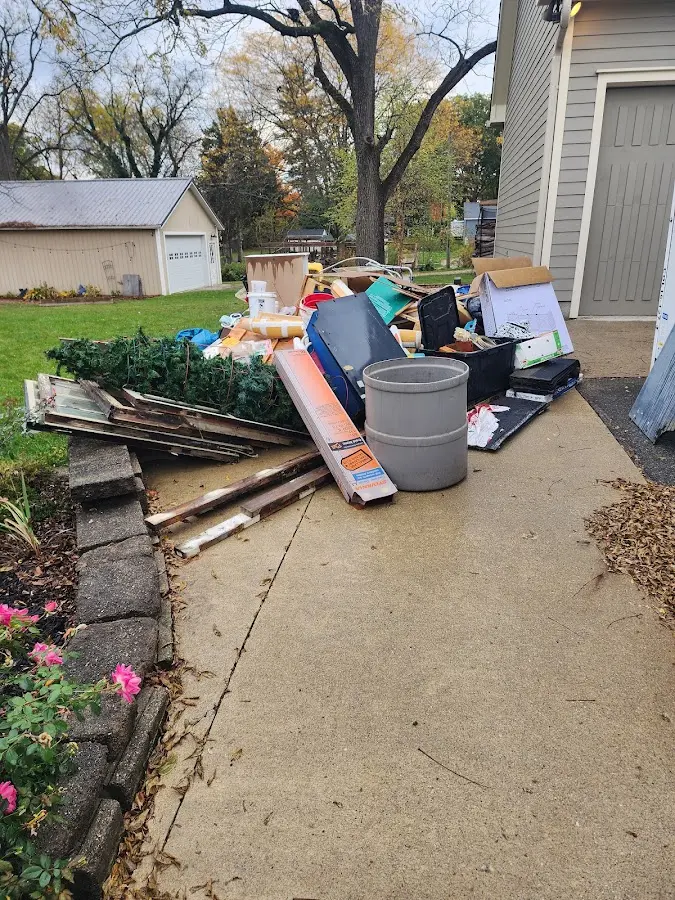 Dumpster being loaded with debris for 12 Yard Dumpster Rental in Crest Hill